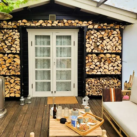 Black-painted Log House Overlooking Vejle Fjord