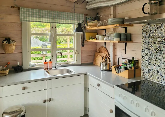Black-painted Log House Overlooking Vejle Fjord *